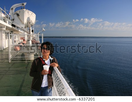 Woman with coffee on a ferry. Atlantic Canada.