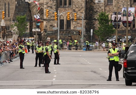 OTTAWA, CANADA - JUNE 30: Police and crowds await the arrival of William and Kate in downtown Ottawa on June 30, 2011 during the first stop of their royal tour of Canada.