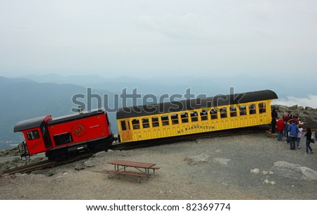 MOUNT WASHINGTON, USA - JULY 8: Tourists board a train on July 8, 2011 on Mount Washington, New Hampshire. The Mount Washington Cog Railway started in 1869 and is the world\'s first such railway.