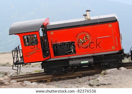 MOUNT WASHINGTON, USA- JULY 8: A passenger train on July 8, 2011 ascends Mount Washington, New Hampshire. The Mount Washington Cog Railway started in 1869 and is the world\'s first such railway.