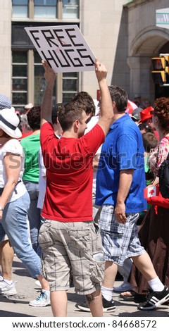 OTTAWA, CANADA - JULY 1: An unidentified young man offering free hugs on July 1, 2011 in Ottawa, Ontario. July 1st is Canada Day and Ottawa is the nation\'s capital city.