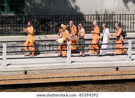 OTTAWA, CANADA – JULY 1: Members of Hare Krishna chanting and walking alongside the Rideau Canal during Canada Day on July 1, 2011 in downtown Ottawa, Ontario.