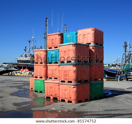 COOK’S HARBOUR, CANADA – JULY 25: Containers of fish stacked at a commercial dock on July 25, 2011 in Cook’s Harbour, Newfoundland. This is one of the larger fishing docks in the region.