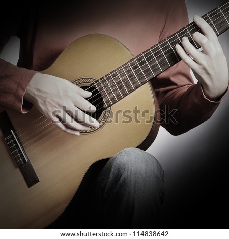 Guitar string music art. Acoustic guitarist playing. Details of musical instrument with performer hands