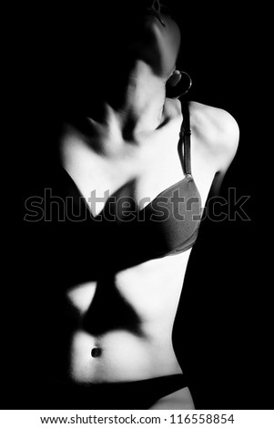 Sexy woman body in lingerie isolated on black background.