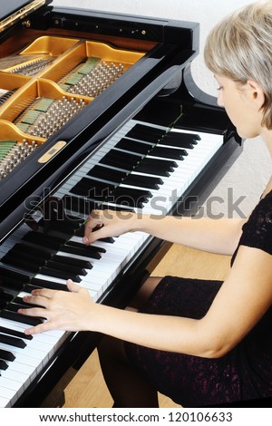 Piano music playing pianist musician. Musical instrument grand piano with beautiful woman performer