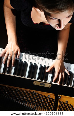Piano music playing pianist musician. Musical instrument grand piano with beautiful woman performer. Focus is on the hands with instrument