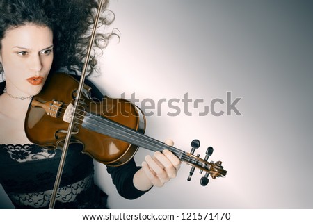 Violin playing violinist musician. Expressive woman musical instrument player