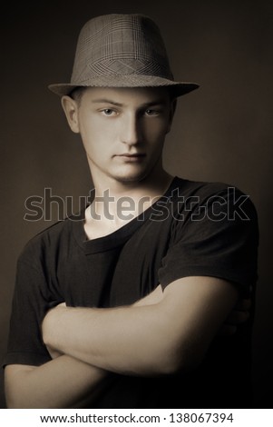 Retro man. Vintage portrait of young handsome man in hat