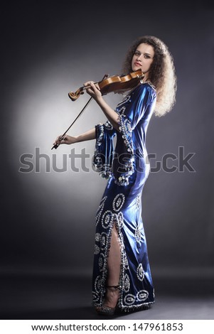 Violin player violinist classical music playing. Orchestra musical instruments