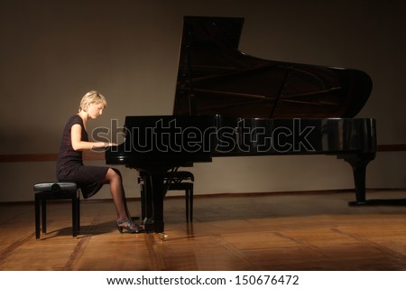 Grand piano pianist playing classical concert. Player with musical instrument
