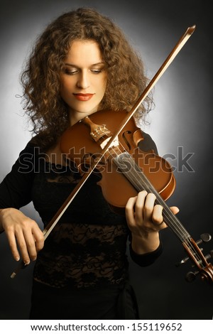 Violin playing violinist musician. Woman classical musical instrument player