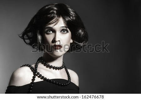 Brunette woman black hair style. Elegant woman hairstyle portrait