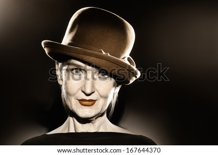 Elegant senior woman in hat fashion portrait. Pretty mature lady 60 years old in retro style