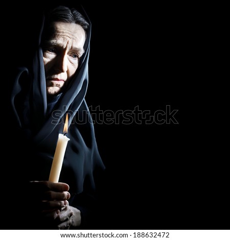 Sad old woman Senior woman in sorrow with candle depressed portrait