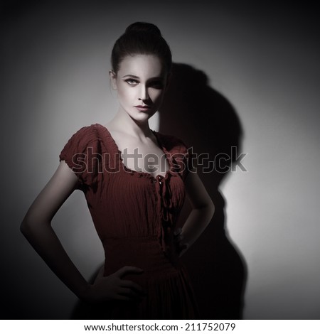Dark portrait of young woman. Fashion model portrait in darkness
