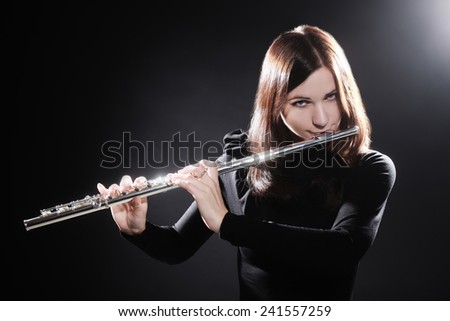 Flutist playing flute music instrument player classical musician