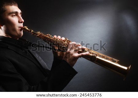 Saxophone player. Saxophonist with soprano sax Man with musical instruments