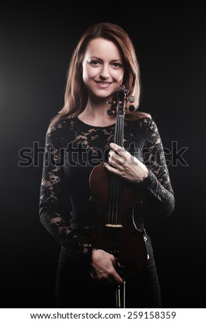 Beautiful woman with violin player Portrait of violinist with music instrument