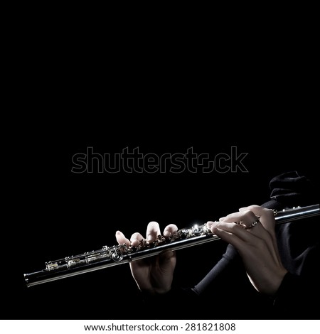 Flute music instrument hands. Flutist playing flute instrument isolated on black