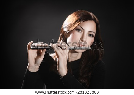 Flute piccolo flutist woman playing flute music instrument