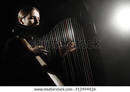 Harp player. Harpist with Musical Instrument Classical Musician playing classic music