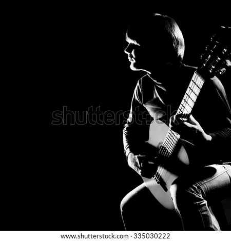 Acoustic guitar player guitarist. Classical guitar musical instrument concert playing in darkness
