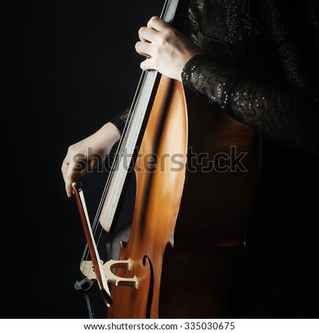 Cello player cellist playing music instrument hands closeup. Orchestra instruments