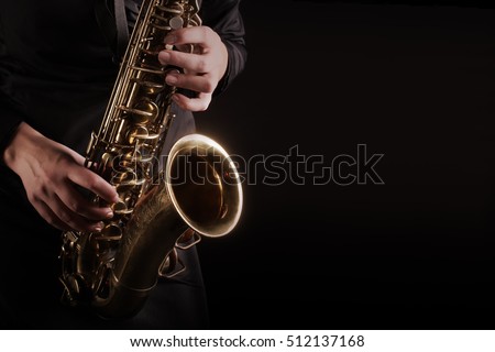 Saxophone Player hands Saxophonist playing jazz music. Alto sax musical instrument closeup