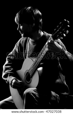 black and white guitar player. stock photo : Guitar concert. Silhouette of guitar player in darkness.