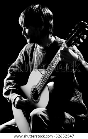 Concert. Silhouette of guitarist isolated on black background. Black and white photo of classical acoustic guitar player