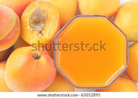 Peaches juice. Glass of freshly squeezed juice and ripe peach close-up