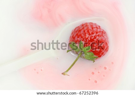 Strawberry yogurt. Yogurt and strawberry in the spoon.