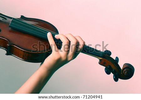 classical music Violin is in the hands of professional violinist. Details of violin playing close-up.