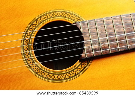 Guitar music art. Acoustic musical instrument on black