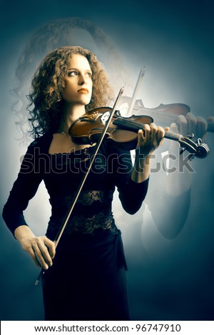 Violin violinist musician player. Inspired woman with classical musical instrument