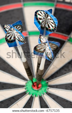 three darts arrows in the bulls eye