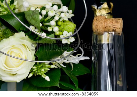 flower arrangement and a champagne bottle and glass
