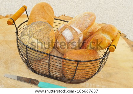 Assorted bread rolls in a bread basket.