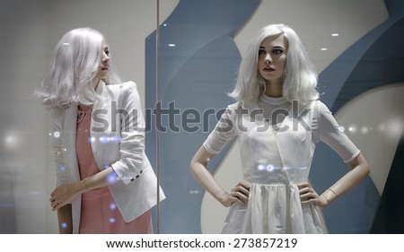 Two female mannequin in the window of the fashionable shop in gentle tones