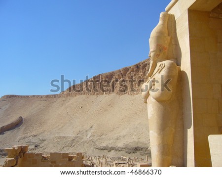 statue looking at the desert in a temple in Egypt