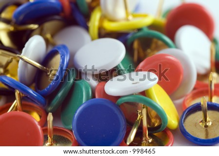 pile of drawing pins with coloured tops