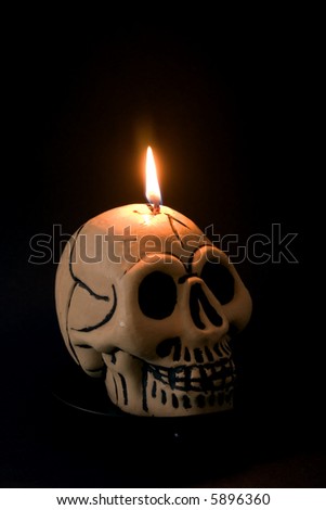 A skull candle against a black background