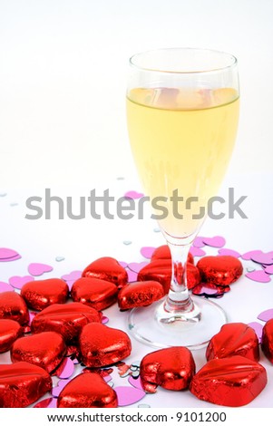 A glass of champagne and chocolate hearts and lips