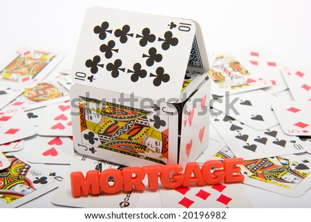 A house made of playing cards on top of a collapsed set of cards