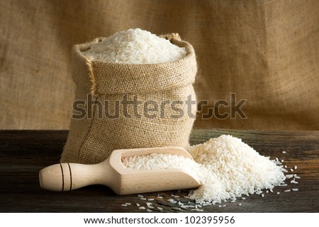 White uncooked rice in burlap bag