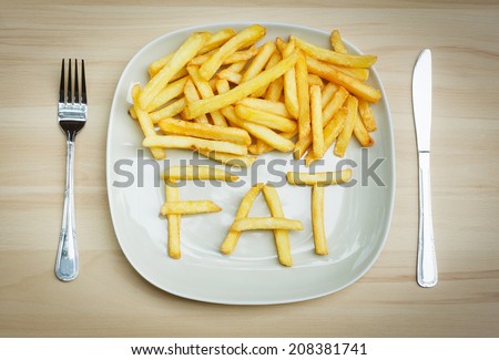 Unhealthy food concept - french fries on a plate