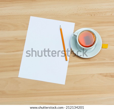 Blank page and cup of tea on wooden background. Empty space for text