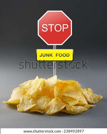 Junk food concept - potato chips and road stop sign