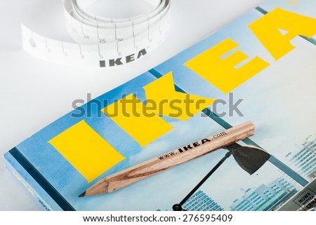 GDANSK, POLAND - MAY 10, 2015. Catalog of IKEA and pencil with measure tape. IKEA is a multinational group of companies that designs and sells ready-to-assemble furniture